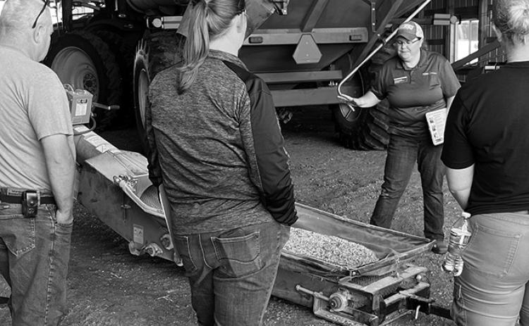 Angie Johnson, NDSU Extension farm and ranch safety specialist, explains safety procedures around an auger. (NDSU photo)