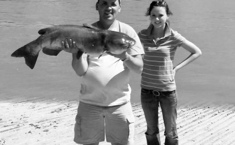 Mike with daughter, Breanna and their monster catfish caught in 2009. Submitted photo.