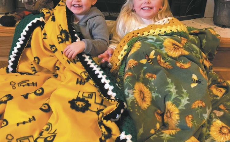 Kolter and Koldie Dahl snuggle under their new Liz’s Kozy Afghans blankets, a Christmas gift from their great-grandmother, Shirley Jensen of Drayton. Photo by Katie Dahl