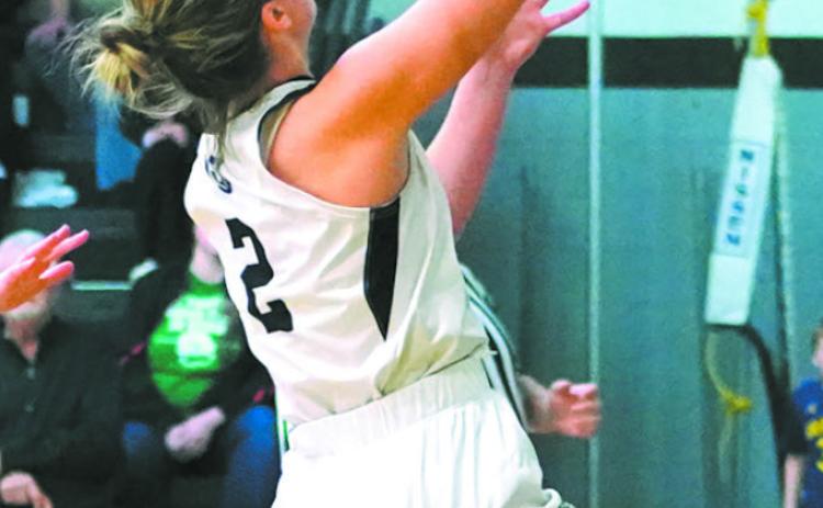 Brooke Gullickson goes for a layup in play against the Mustangs. Photo by Larry Stokke.