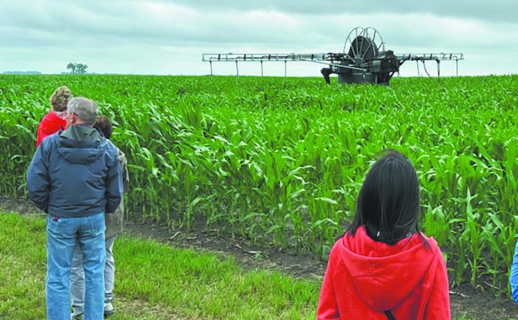 Attendees watch the 360 Rain autonomous irrigation applicator in action in SE North Dakota as part of the North Dakota Water Education Foundation 2025 Water Tour series. Photo provided by ND AgTech Engine.
