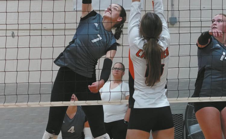 Elizabeth Fedje slams down one of her 15 kills in the Titans win over Cavalier Oct 3 in Cavalier. Photo by Larry Stokke