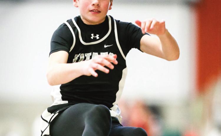 Sam Kittelson makes an effort during the long jump last Friday Night at UND. Photo by Cole Short courtesy of Hillsboro Banner