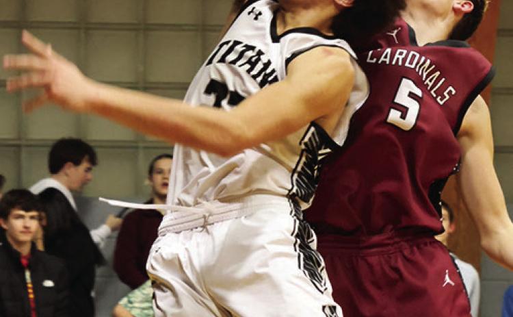 Facing heavy defense from Langdon's Terrell Henderson, DVE's Mason Pollestad fights for the shot. Photo by Jamie Rarick