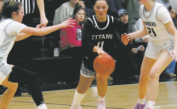MORE SPORTS PAGE 2 Jacey Nelson splits through the Nelson County defenders on her way towards the basket. Photo by Jamie Rarick