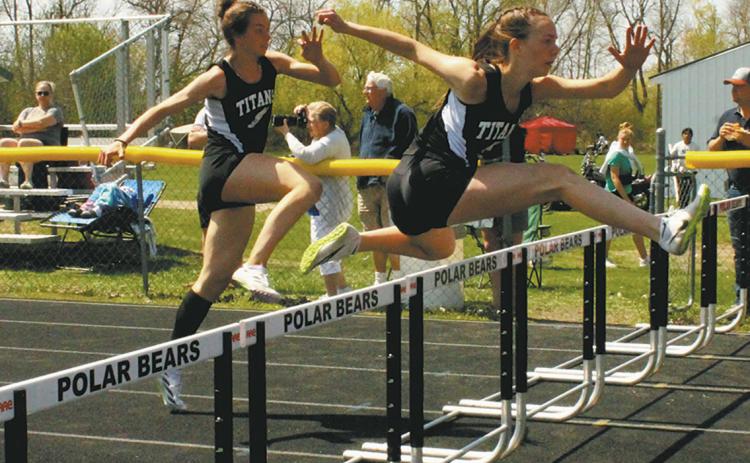 DVE teammates Jocelyn Vold and Elizabeth Fedje leap over the hurdles to a 2nd and 3rd place finish respectively, both moving on to the state competition in the womens 100m hurdles. Photo by Jamie Rarick