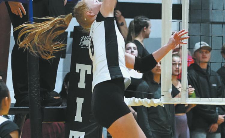 Peyton Larson slams the ball over the net in the match versus Park River. Photo by Larry Stokke