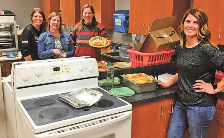 Pictured above Left to right: Track Moms serving supper: Natalie Feltman, Stacey Reilly, Naomi Myrdal and Sara Gullickson. Photo submitted