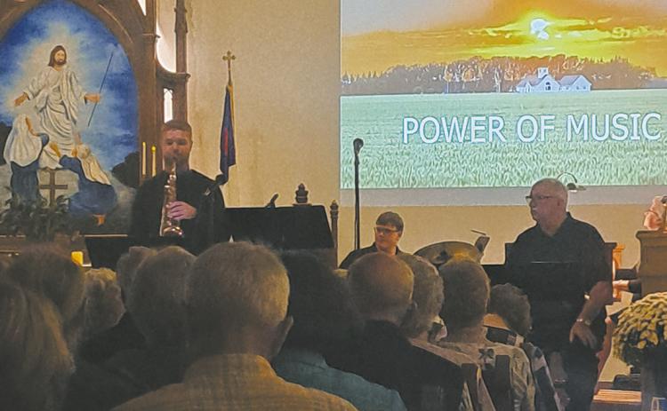 Andrew Danielson, Ian Petrerson and John Maxwell performing at “The Power of Music.” Photo by Christine Jensen