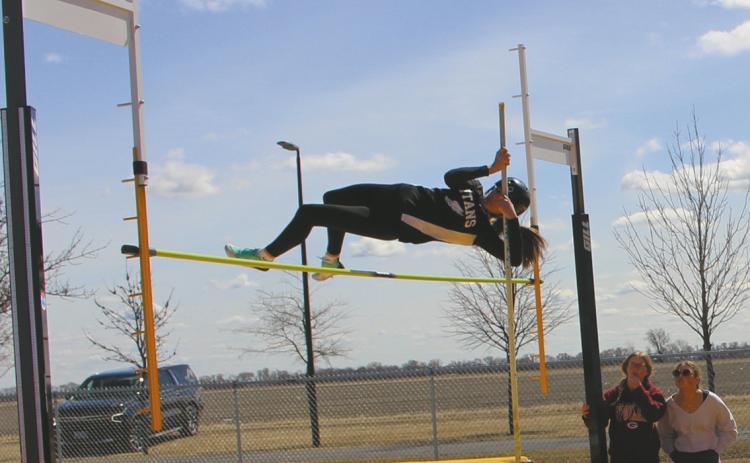 Rosalyn Fedje puts plenty if air between herself and the bar while pole vaulting at the meet in Grafton last week. Photo by Andrea Johnston