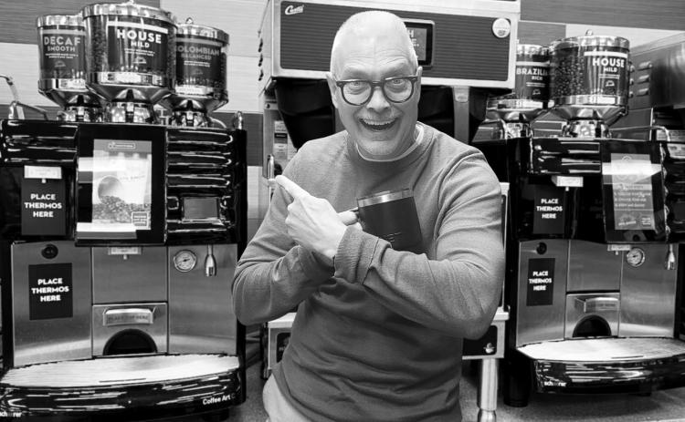 Bob gives an enthusiastic endorsement of his favorite coffee machine at Love’s Travel Stop, mug in hand and pointing to the Swiss-made Schaerer brewer behind him.