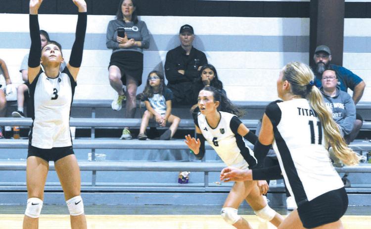 DVE's Milla Fagerholt sets up the ball, as teammates Gianna Hall and Reegan Aasand race to make the play. Photo by Jamie Rarick
