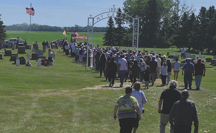 A procession through the cemetery followed the final mass held last Sunday. Reverend Schill discussed how the Our Lady Mt. Carmel Cemetery Fund is currently at $40,000, but needs to be closer to $100,000 to be a viable, lasting foundation. Photo by Hilary Nowatzki.