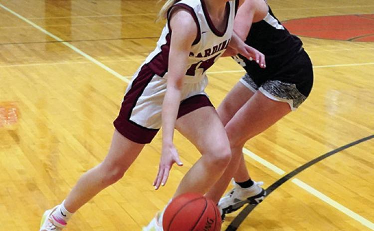 Editor’s note: This is the final year of educational instruction for Edmore Public School. Tip off for the very last game on Edmore’s home court was at 7 p.m. on Thursday, Jan. 25 when the Langdon-Edmore-Munich girls basketball team played one last game at the school against Drayton-Valley-Edinburg. Hilary Haaven drives around D-VE’s Greta Burrell at Edmore gym’s final game. Photo by Larry Stokke.