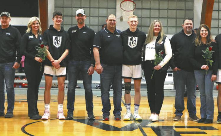 The Titans seniors stand with their parents on Senior Night, which was celebrated Feb. 13 at the game against Park River. Photo by Lyle Van Camp.