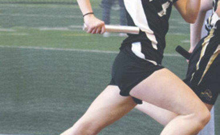 Easton Larson running a leg of the girls’ 4 x 300 relay. Photo by Lyle Van Camp.