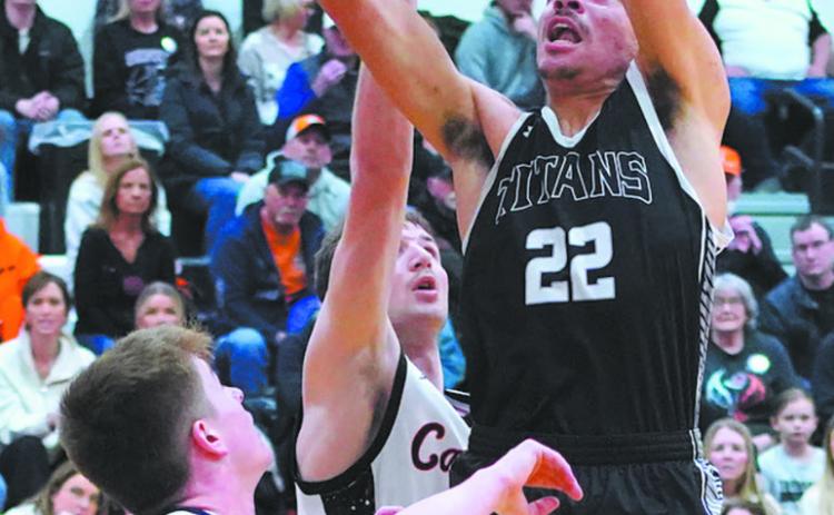 Mason Pollestad goes for the dunk during play against Cavalier in the District 3 tournament action. Photo by Larry Stokke
