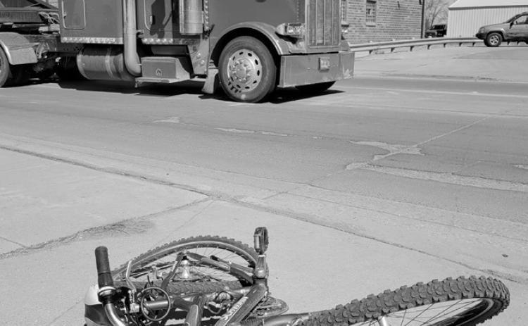 The victim's bicycle is seen lying on the sidewalk following the accident involving a semi near Hugo’s in Grafton. Photo by Mike Alan Steinfeldt