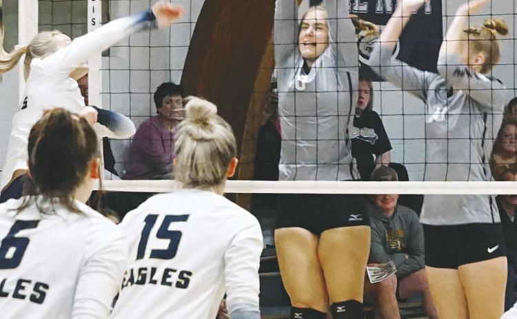 Emily Gonzalez and Claire Thompson both go for a dig against the NB Eagles. Photo by Larry Stokke Kiara Assand with a stuff block against the North Border Eagles . Photo by Larry Stokke.