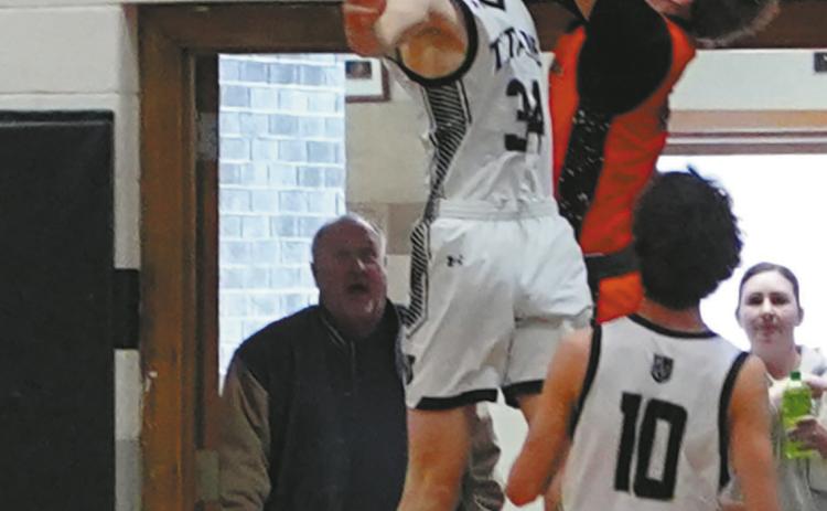 Jack Langerud gets his hand on Breckon Thorpe’s shot for a nice block against Cavalier in Edinburg on Jan. 6. Photo by Larry Stokke