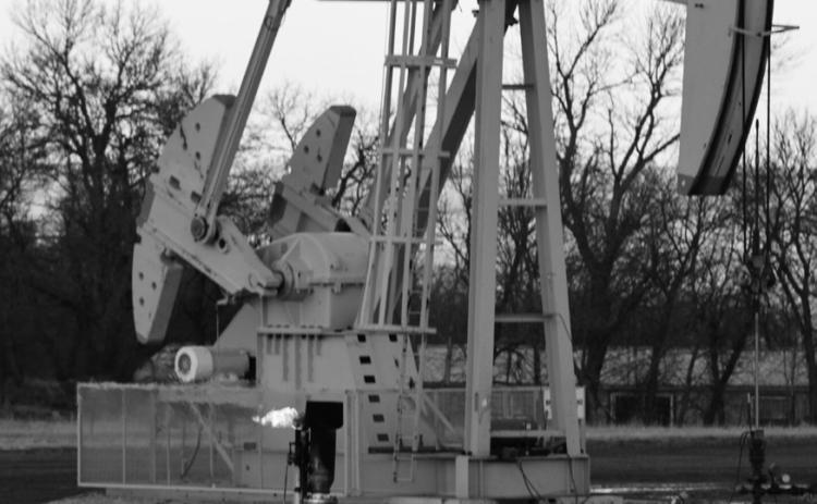 A gas flare burns in front of an oil pumpjack near Killdeer, North Dakota, on Feb. 1, 2024. copy.jpg