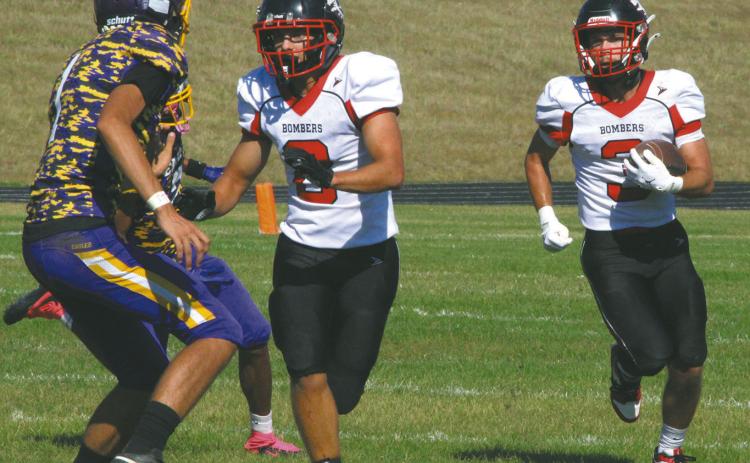 Bomber linebacker Carter Johnson clears the way for teammate Trenten Keena to make a run against the Eagles defense. Photo by Jamie Rarick