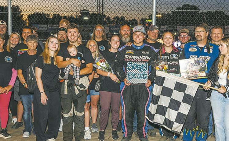 Friends and family surround Tucker, Joey and Kelsi Pederson during the Hall of Fame induction Friday, Aug. 7 at River Cities Speedway in Grand Forks. Photo by Robert Dusso, Dusso Photography