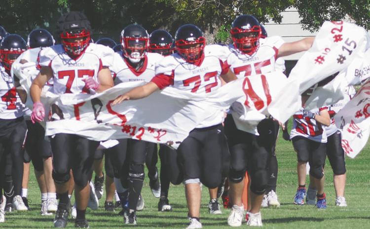 The Bombers take to the field to start the final regular season home game of the season. Photo by Lyle Van Camp