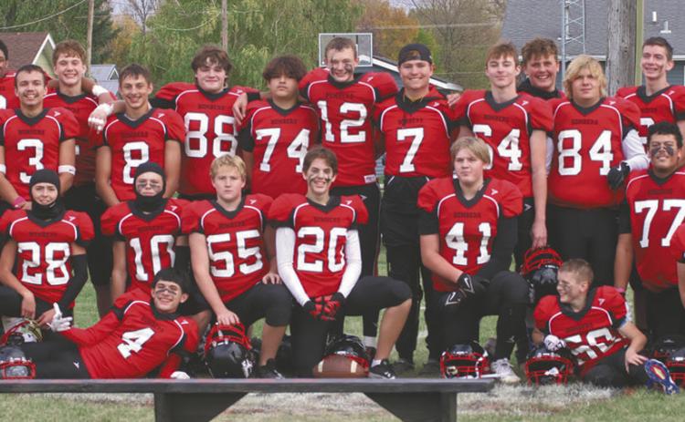 The Bombers players and coaches possed for photos after winning their semi-final game last Saturday. Photo by Lyle Van Camp