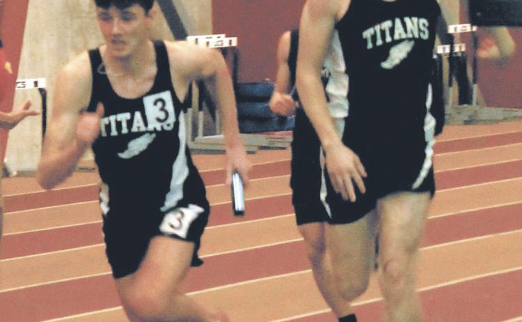The baton is handed from Carter Oberg to anchor Brady Reilly to finish the 4x300 relay. The team finished 1st with a new school record of 2:36.56. Photo by Jamie Rarick