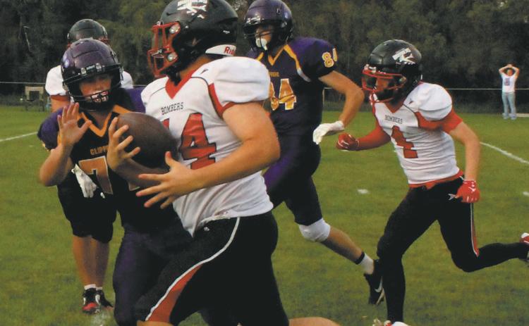 Fighting off the Clipper defense, Praise Chairez carries the ball for a Bomber touchdown. Photo by Jamie Rarick