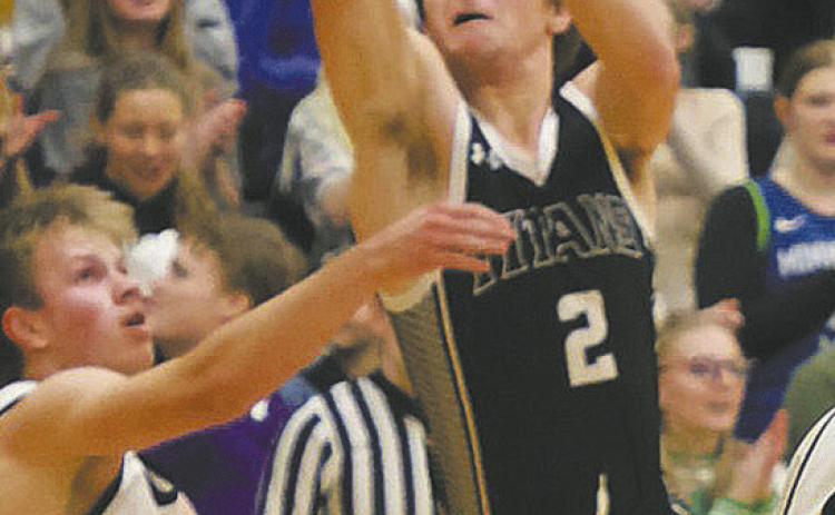 DVE junior Teddy Otto goes for the shot over an Aggie defender. Photo by Jamie Rarick