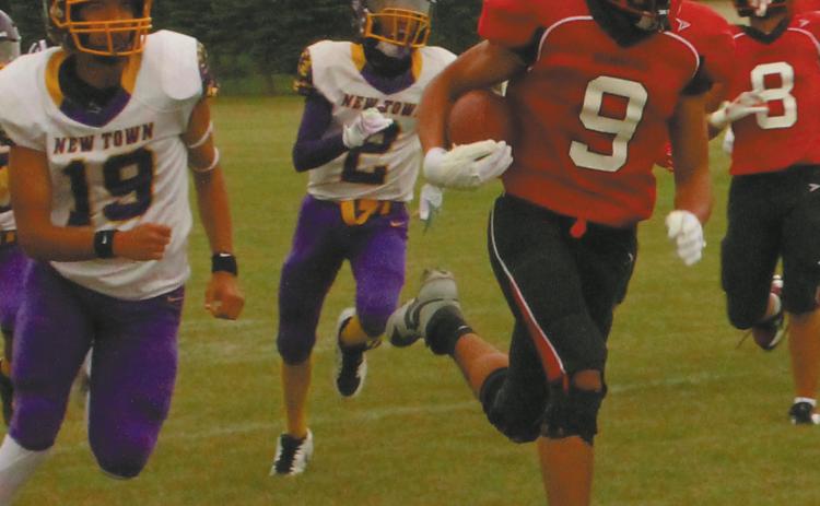 Mason Pollestad outruns the Eagle defense for another Bomber touchdown gainst New Town. Photo by Jamie Rarick.