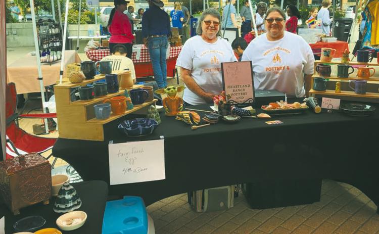 Elizabeth Linster and her sister, Sherry selling Heartland Ranch Pottery at a street fair. Submitted photo.