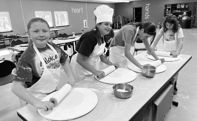 Youth campers make tortillas and pizza dough from scratch at a North Dakota 4H Camp last year in Washburn. Camp participants also took part in a Healthy Camp Challenge where all children received pedometers to track their daily step total while in camp. Photo provided by NDSU Extension.