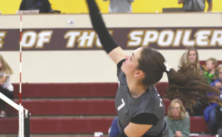 Elizabeth Fedje puts down a kill in regional tournament action Monday evening in Grafton. Photo by Lyle Van Camp