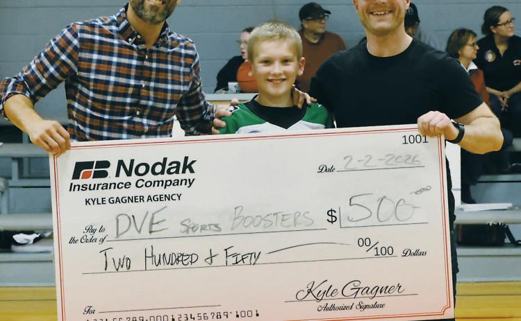 At half-time, a check was presented by Kyle Gagner of Nodak Insurance, pictured with Kyle Johnson and Ryan Beattie. Photo by Jamie Rarick