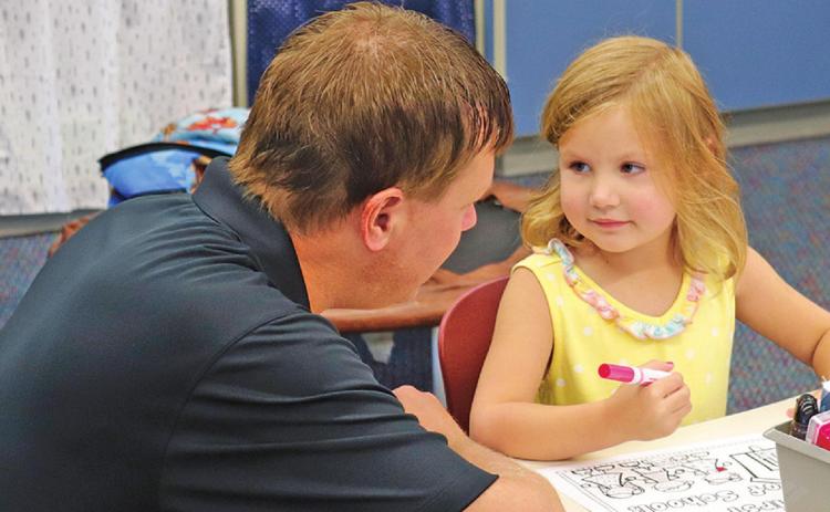 Jason Melland and daughter Berklee share a sweet moment as they say goodbye on the first day of school as she starts Kindergarten. VNV Photo by Lesa Van Camp