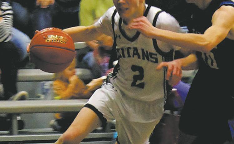 DVE senior Quinn Passa drives past a Griggs-Midkota's defender in Edinburg Feb. 8. Photo by Jamie Rarick