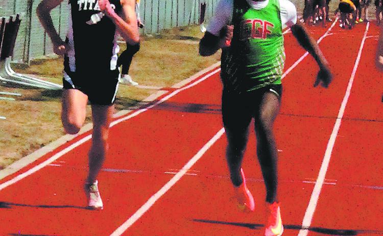 DVE senior Brady Reilly sprinted hard to the finish line against East Grand Forks competitor in the men’s 100 meter dash during the meet in Grafton last week. Reilly had a successful day, earning state qualification in both the 200 m and 400 m events. Photo by Jamie Rarick