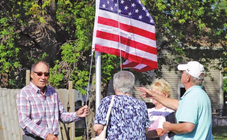 David Kirkeby’s siblings raise the flag in his memory last Wednesday morning. VNV Photo by Lesa Van Camp