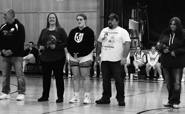 Seniors and their parents on Senior Night. From the left; Jessie Aasand, Kira Aasand, Mike Aasand, Andrea Douville, Isabella Douville, Justin Douville, Lacey Wherley, and Trinity Wherley. Photo by Lyle Van Camp.