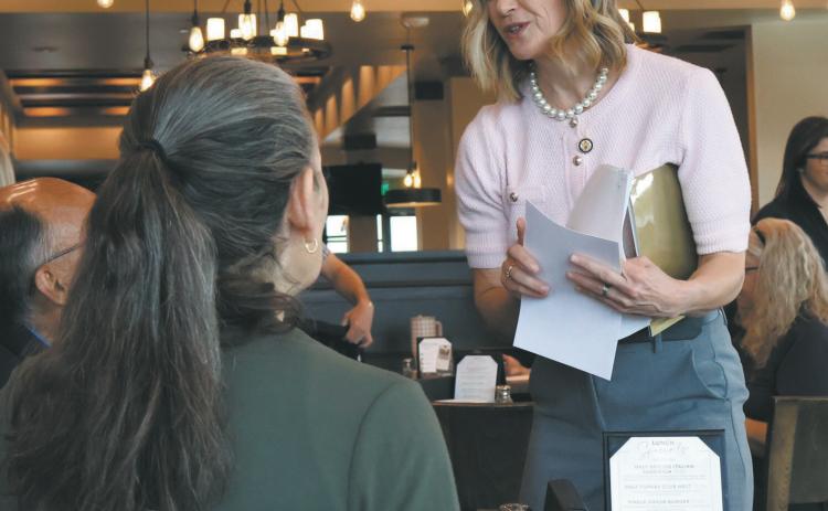 Rep. Julie Fedorchak, R-N.D., hands out informational packets on Trump Accounts during an event in Bismarck discussing the new accounts on May 11, 2026. Photo by Michael Achterling/North Dakota Monitor