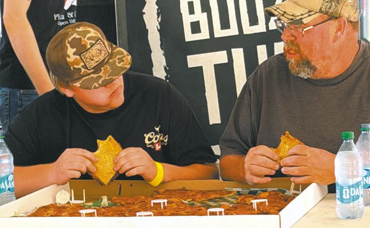 Johnny and Greg Osowski bond over a 28-inch Behemoth pizza at the Greater Grand Forks Fair. Photo by Katie Dahl
