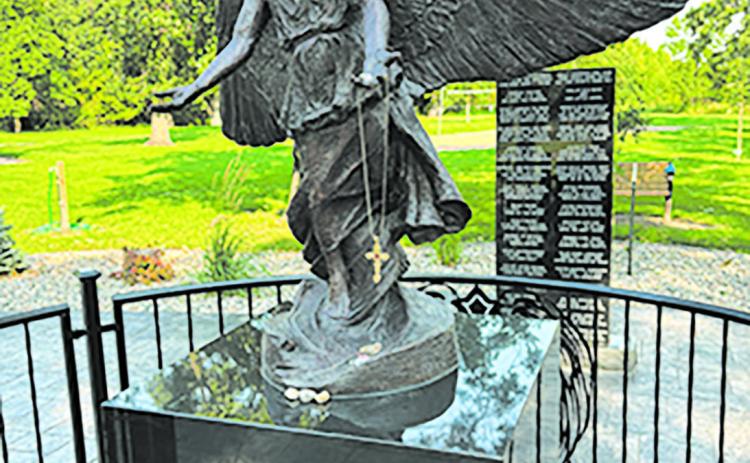The Angel of Hope monument in Leistikow Park is adorned with memorial trinkets left by loved ones. Photo by Andrea Johnston