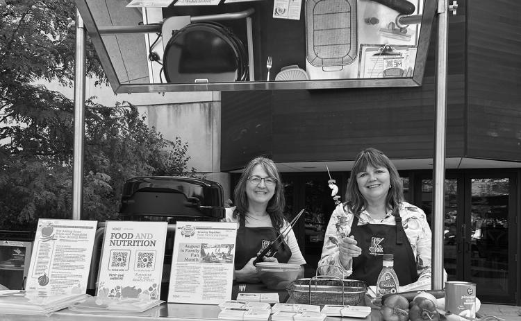 Julie Garden-Robinson, NDSU Extension food and nutrition specialist, and Beth Dahl, grant coordinator, share a cooking demo at the Red River Market. (NDSU photo)