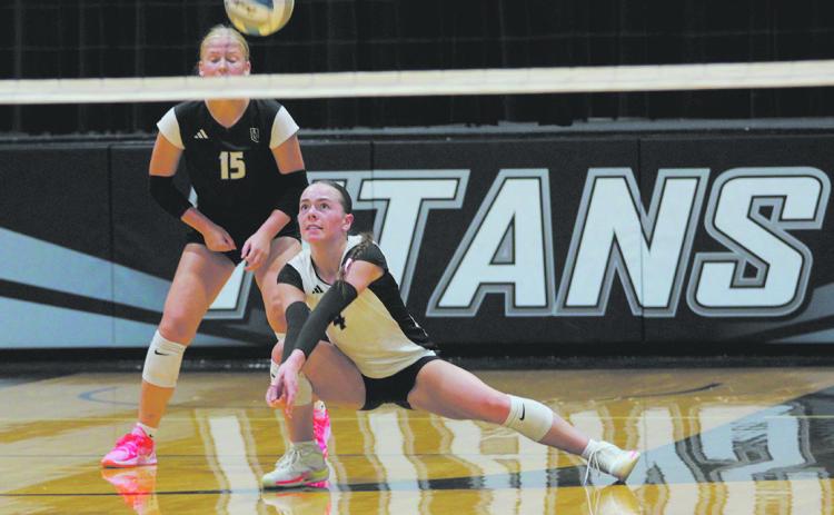 Stretching low to the ground, DVE junior Jocelyn Vold gets under the ball to make the play. Photo by Jamie Rarick