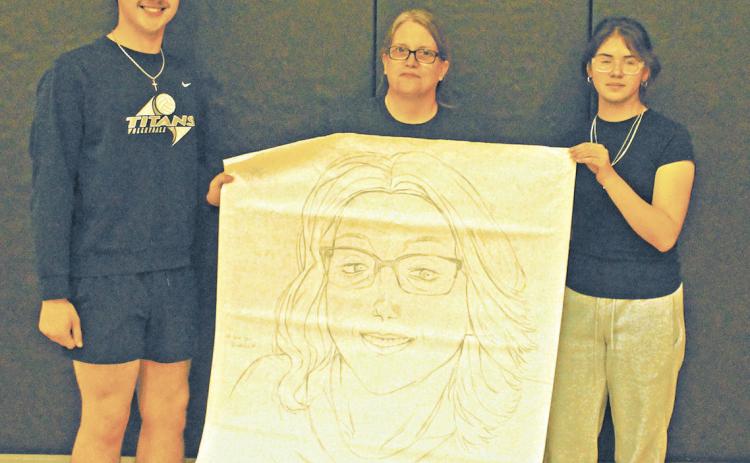 Maddox Oihus and Allisson Chavez represented the junior class for the drawing contest during Friday's spirit week activities. They won with their portrait of Drayton School Secretary Denise Cole. Photo by Jamie Rarick.