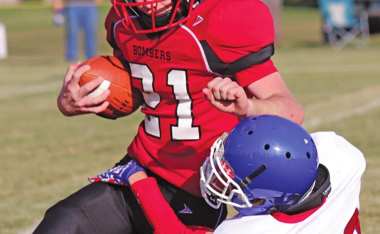 Cayden Quibell attempts to gain some yards before being taken down by Wildcat Jack Sailer in Saturday afternoons match up on the Drayton grid iron. VNV Photo by Lesa Van Camp