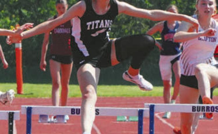 Elizabeth Fedje hurdling herself to first place. Photo by Larry Stokke.
